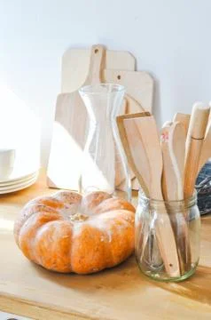 Pumpkin and kitchen ware on a table. Close up. Stock Photos