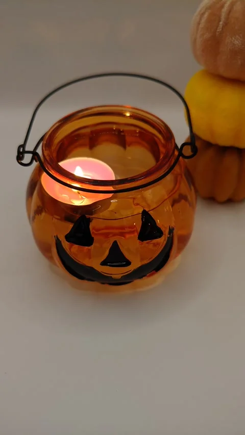 Pumpkin and red candle in the dark, top view. Halloween Stock Footage 319789613