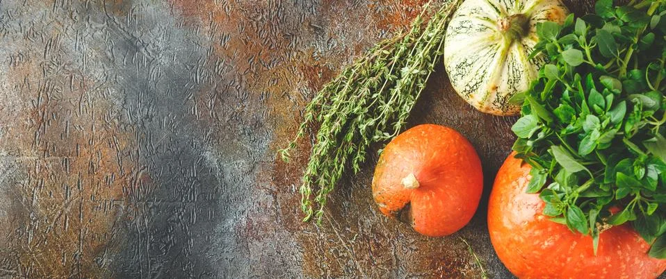 Pumpkin, basil and thyme on a rusty background Stock Photos