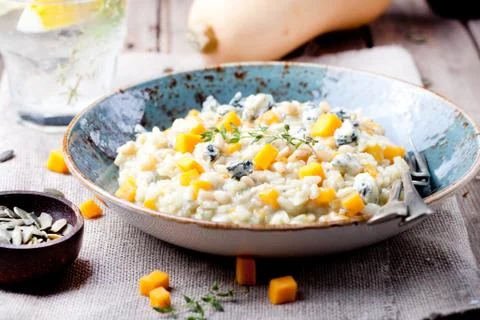 Pumpkin, blue cheese risotto in a ceramic plate Stock Photos