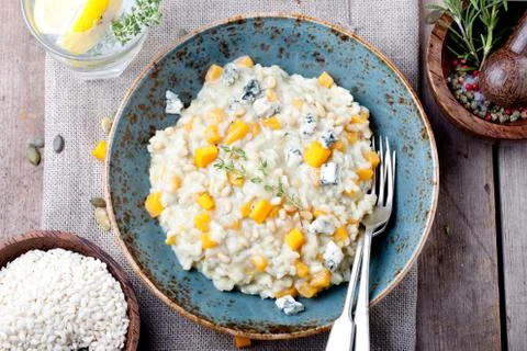 Pumpkin, blue cheese risotto in a ceramic plate Stock Photos