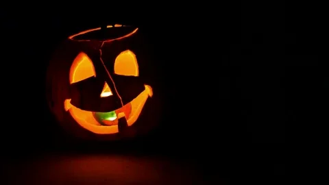 Pumpkin with burning candle, pan left Stock Footage 85112931