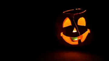 Pumpkin with burning candle, pan right Stock Footage 85968552