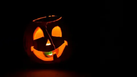 Pumpkin with burning candle, tilt down 스톡 동영상 85970701