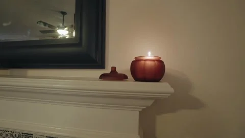 Pumpkin candle on fireplace with mirror Stock Footage 292019146