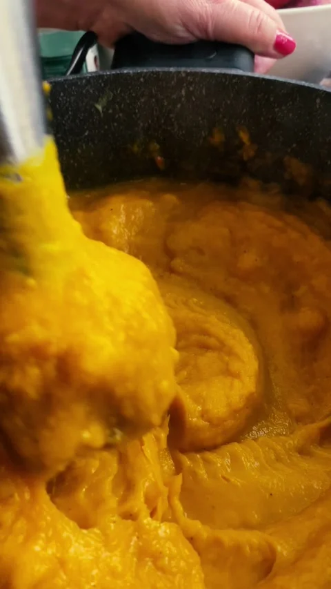 Pumpkin cream. Warming Pumpkin Soup, Blending Pumpkin in a Pot, Vertical Video Stock Footage 218447469