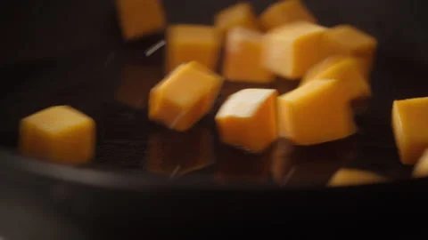 Pumpkin cubes falling into the pan Stock Footage 135005850