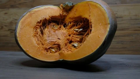 Pumpkin cut in half with pumpkin guts, slider shot Video stock 117751810