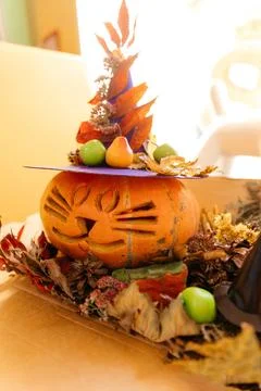 Pumpkin in the form of a cat in a fruit hat Stock Photos