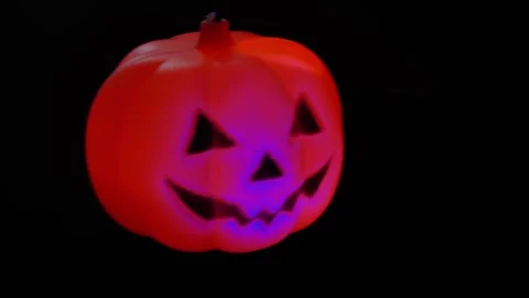 Pumpkin glows on a black background. Halloween on the background of the night Video stock 253109652