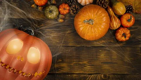 Pumpkin head Jack-o'-lantern and different small pumpkins, cones, acorns and Stock Photos