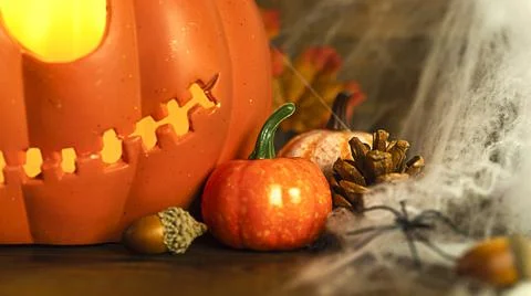 Pumpkin head Jack-o'-lantern close-up with glowing eyes and orange autumn Stock Photos