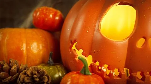 Pumpkin head Jack-o'-lantern and different small pumpkins, cones, acorns and Stock Photos