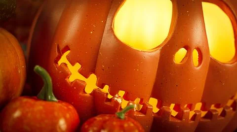 Pumpkin head Jack-o'-lantern and different small pumpkins, cones, acorns and Stock Photos