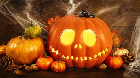 Pumpkin head Jack-o'-lantern and different small pumpkins, cones, acorns and Stock Photos