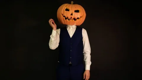 Pumpkin-headed man talking on the phone. Halloween concept.carved pumpkin Video stock 116229647
