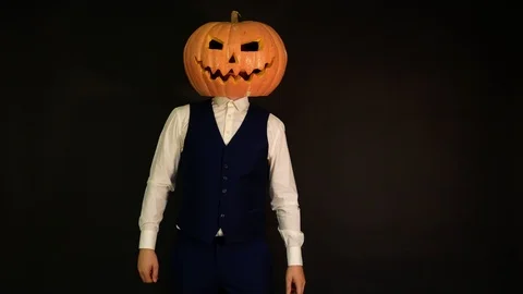 Pumpkin-headed man talking on the phone. Halloween concept.carved pumpkin Stock Footage 116233188