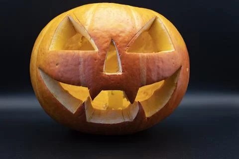 Pumpkin (Jack-o-lantern) close-up on a black background Stock Photos
