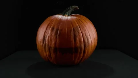 Pumpkin Jack O Lantern Spinning Against a Dark Black Background for Halloween Vidéo 331110436