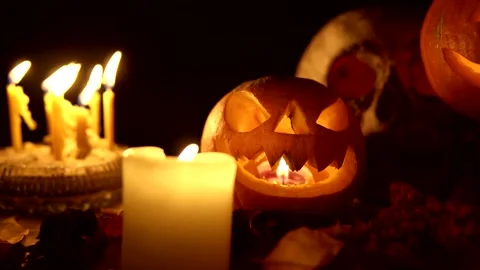 The pumpkin lantern on black background among candles dolly camera movement. Stock Footage 139495327
