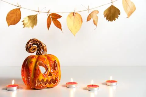 Pumpkin lantern jack and burning candles. Halloween composition. Home decor Stock Photos