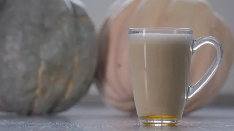Pumpkin latte in a glass cup Stock Footage 88865560