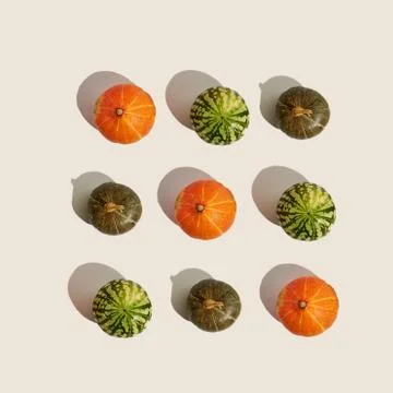 Pumpkin pattern on beige background with sunlight shadow, Halloween Stock Photos