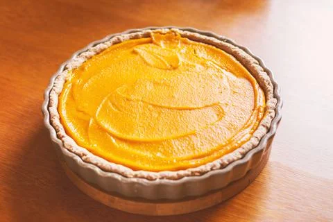 Pumpkin pie, orange cake in a baking dish Stock Photos