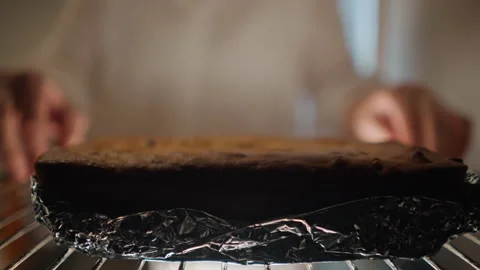 Pumpkin pie preparation. Baking aroma fills kitchen as pie is transferred Stock Footage 348298970