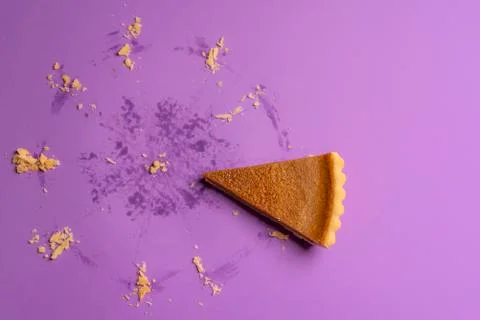 Pumpkin pie slice and the traces of a whole pie. Above view. Stock Photos