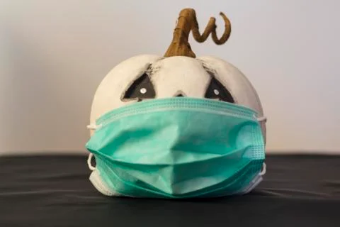 Pumpkin with protective face mask. Concept of halloween during covid-19 pande Stock Photos