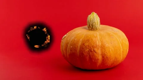 Pumpkin on red background with magical effect Stock Footage 342831633
