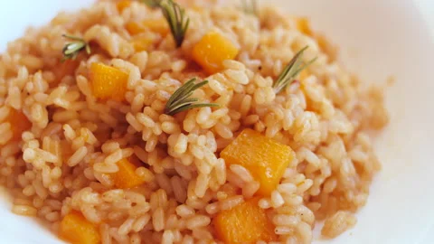Pumpkin risotto, recipe with rice and pumpkin on rustic table with ingredient Stockbeeldmateriaal 142145026