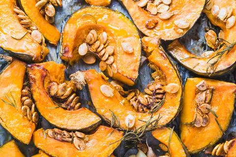 Pumpkin roasted slices background. Stock Photos