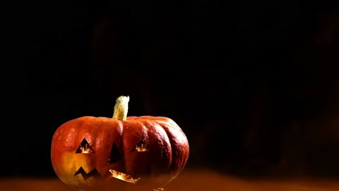 Pumpkin with scary face in smoke Stock Footage 142087603