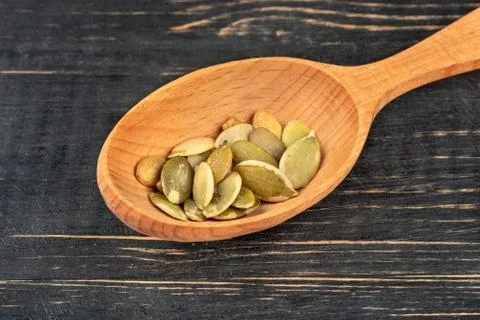 Pumpkin seed kernels in spoon Stock Photos