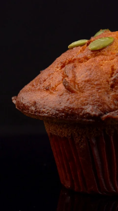 Pumpkin Seed Muffin Rotating on Dark Background Under Studio Lighting Stock Footage 330517443