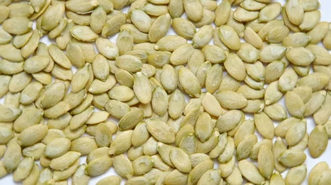 Pumpkin seeds are spinning on a table. Stock Footage 35366193