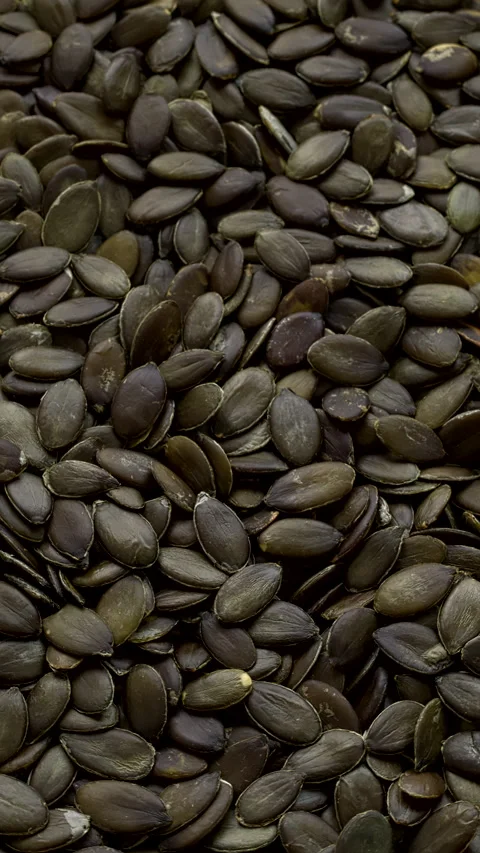 Pumpkin seeds background. Selective focus. Vertical video. Stock Footage 300947418
