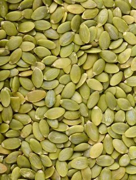 Pumpkin seeds background, top view Stock Photos