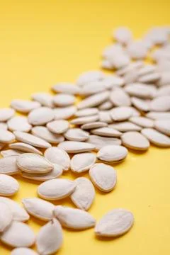 Pumpkin seeds background, vertical image. Blurred photo Stock Photos