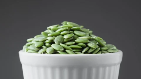 Pumpkin seeds on black background rotating. Vegetarian nutrition. Green seeds. Stock-Footage 293951876