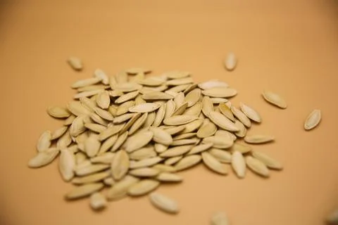 Pumpkin seeds in a brown background Stock Photos