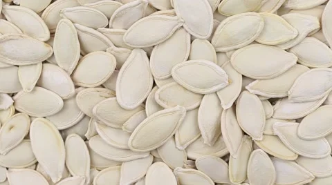 Pumpkin seeds close up. Front of the camera rotates plate with pumpkin seeds Stock Footage 64485233