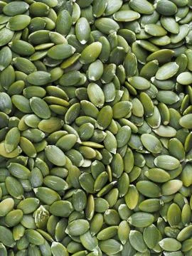 Pumpkin seeds close-up in full screen. Peeled pumpkin seeds without peel. Stock Photos