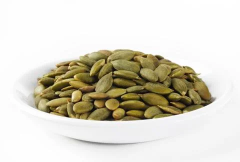 Pumpkin seeds on dish Stock Photos