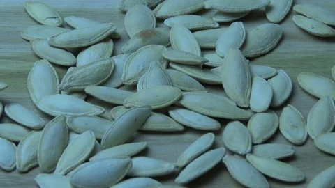 Pumpkin seeds fall on the table Video stock 79593592