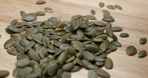 Pumpkin seeds falling and rotating studio macro Stock-Footage 101470436