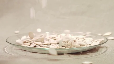 Pumpkin seeds falling down into glass bowl 스톡 동영상 72116767