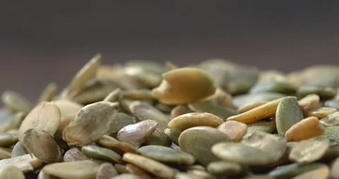 Pumpkin seeds falling in super slow motion Stock Footage 342590512